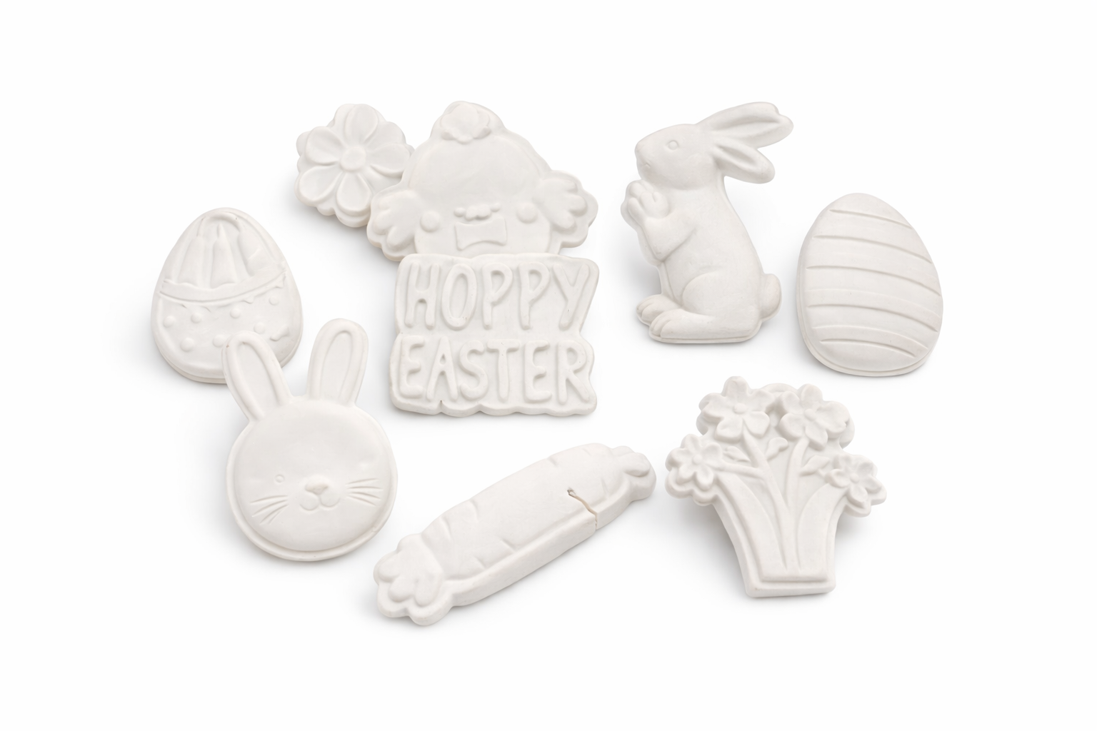 White plaster Easter molds set with bunnies, eggs, flowers, carrot, and Hoppy Easter sign
